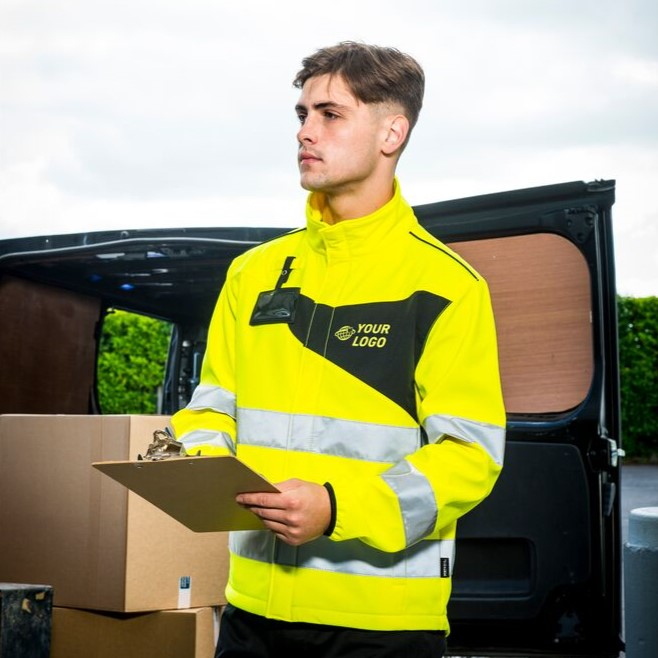 Worker in yellow protective clothing holding a clipboard.
