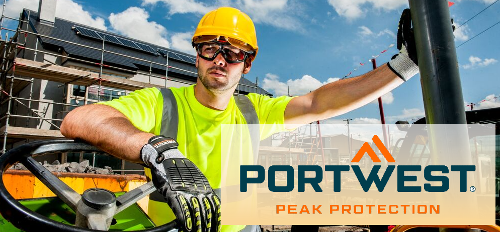 Construction worker with safety goggles, helmet, and gloves on a construction site; in the foreground, the Portwest logo with the slogan "Peak Protection."