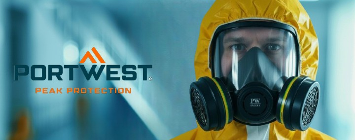 A worker in a yellow protective suit. Only his head and part of his shoulders are visible. He is wearing the Vienna P500 full-face mask. The background is blue and blurred. The orange and blue Portwest logo is visible on the left side of the image.