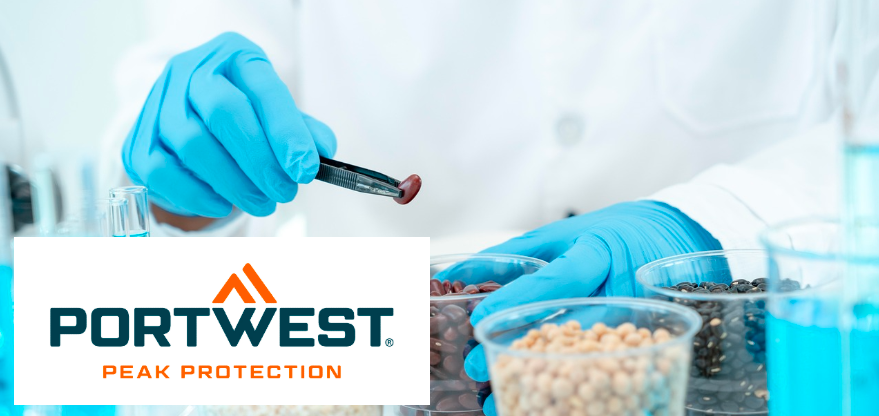Excerpt from a laboratory scene: Two hands wearing blue disposable gloves are visible, one holding a plastic beaker with kidney beans, the other holding tweezers with a bean. The person is wearing a white lab coat. On the table are other plastic containers with other legumes. The Portwest brand logo in blue and orange against a white background is at the bottom left of the image.