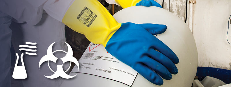 Worker with Portwest chemical resistant gloves handling dangerous items.